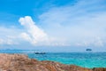 Rock Beach with crystal clear water and boat Royalty Free Stock Photo