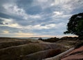 Rock beach in the morning with beautiful sunrise sky. Big stone and tree at coastal. Calm sea and tropical beach. Tranquil