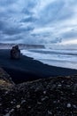 Rock on black sand beach