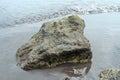 Rock on the black sand of the beach Royalty Free Stock Photo