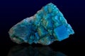 Rock of blue calcite mineral on dark background. Royalty Free Stock Photo