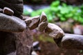 Rock bridge, pyramid, rock balancing art. Close-up of a stack of stones in perfect balance in a mountain forest. Royalty Free Stock Photo