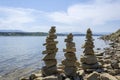 Rock cairn the art of stone balancing on a stone near a blue water flowing lake.