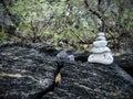 This is a rock cairn made of white coral sitting on lava rock in Maui near Kihei in Ahihi-Kinau Natural Area Reserve