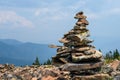 Rock cairn on a mountain peak built out of broken pieces of dacite rock weathered by time and exposure to the elements