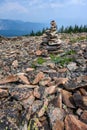 Rock cairn on a mountain peak built out of broken pieces of dacite rock weathered by time and exposure to the elements