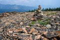 Rock cairn on a mountain peak built out of broken pieces of dacite rock weathered by time and exposure to the elements