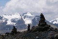 Rock cairns with the white snow capped mountain peaks of the Cordillera Blanca Andes mountain range in the background. Location: Royalty Free Stock Photo