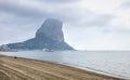 The rock of Calpe `Ifach` during foggy morning along sand beach, Calpe, Spain Royalty Free Stock Photo