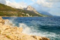 Rock Cliff Blue Sea Waves with splash Royalty Free Stock Photo