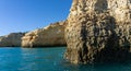 Rock and cliff coast under a brigh blue sky with sea caves on the Atlantic coast