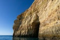 Rock and cliff coast under a brigh blue sky with sea caves on the Atlantic coast