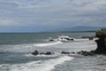 Rock cliffs in the Indian Ocean off the coast of Bali island, near Batu Bolong and tourism attraction spot Tanah Lot temple. Waves Royalty Free Stock Photo