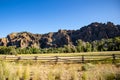 Rock cliffs and a pature with horses on it in Wyoming