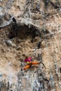 Rock climber girl in orange pants leaging climbing route on natural rock Royalty Free Stock Photo