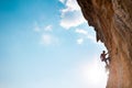 Rock climber on the background of blue sky