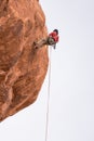 Rock climber belaying down hoodoo