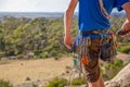 A rock climber checks his gear and radio before climbing Royalty Free Stock Photo