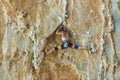 Rock climber on tufas climbing route in Kalymnos, Greece