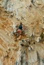 Rock climber lead climbing on challenging overhanging climbing route on tufa rocks