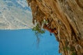 Rock climber lead climbing on challenging overhanging climbing route on tufa rocks