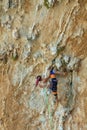 Rock climber on tufas climbing route in Kalymnos, Greece