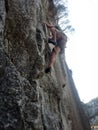 Rock climber climbing granite wall shot from underneath Royalty Free Stock Photo