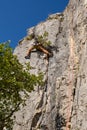 Rock climber climbing high mountains in Crni Kal Slovenia