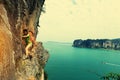 Rock climber climbing at seaside mountain cliff Royalty Free Stock Photo