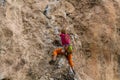 Rock climber girl leaging climbing route on natural rock Royalty Free Stock Photo