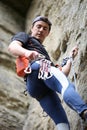 Rock climber going to fix quickdraw to rock Royalty Free Stock Photo