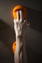 Rock climber gripping handhold with two fingers