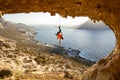 Rock climber hanging on rope after falling of cliff, climbing in cave