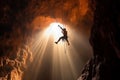 rock climber hangs on a rope in a deep abyss, the sunlight filtering through the rocks as they display their strength