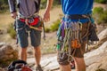 A rock climber belays his partner while he climbs up a rock wall Royalty Free Stock Photo