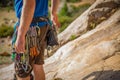 A rock climber belays his partner while he climbs up a rock wall Royalty Free Stock Photo