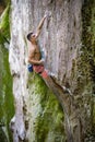 Rock climber holding rope with teeth before making clip Royalty Free Stock Photo