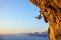 Rock climber jumping on handholds while climbing cliff Royalty Free Stock Photo