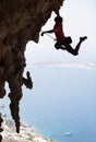 Rock climber jumping on next handhold Royalty Free Stock Photo