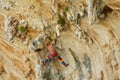 Rock climber lead climbing on challenging overhanging climbing route on tufa rocks