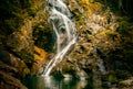 Rock Climber next to Waterfall in Natural Landscape at Sunset, Hong Kong