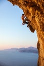 Rock climber on overhanging cliff.