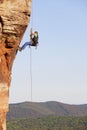 Rock climber and photographer rappeling from a sandstone rock Royalty Free Stock Photo