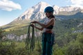 A rock climber prepares equipment for climbing