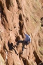 Rock Climber Rapelling Down Face of Rock Formation