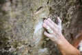 Rock climber`s hand gripping small hold on natural cliff Royalty Free Stock Photo