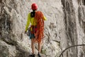 Rock climber standing in front of mountain cliff outdoor