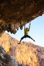 Rock climber struggling on challenging route on cliff Royalty Free Stock Photo