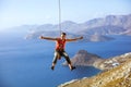 Rock climber swinging on rope and showing thumbs up Royalty Free Stock Photo