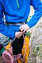 A rock climber tie a knot for insurance. Royalty Free Stock Photo